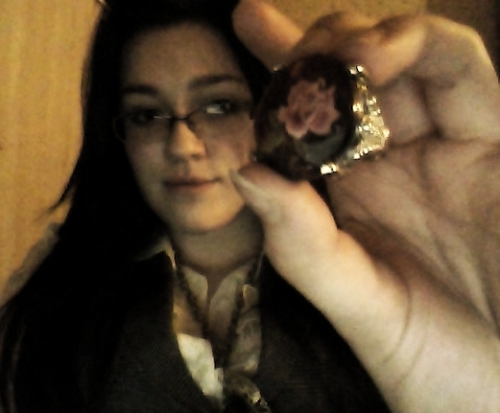 Grainy picture, but it's a gem atop a rose decal, with fancy metalwork.